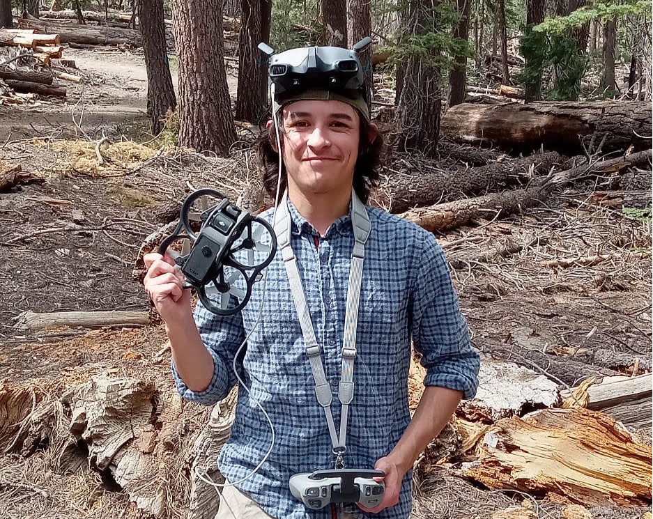 Drone pilot holding drone and remote